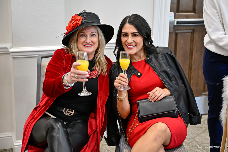 Two women toasting with glasses of orange juice